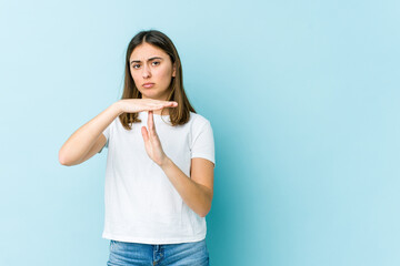 Young caucasian woman showing a timeout gesture.