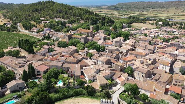 Scenic aerial view of French township of Fontcouverte at foot of Alaric mountain on sunny summer day, Aude, Occitanie