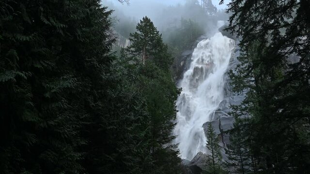 Dream-like photo of the Shannon Falls. Dense fog makes the scene so surreal, like the fall is flowing directly from the clouds, in Shannon Falls Provincial Park in Squamish, British Columbia, Canada