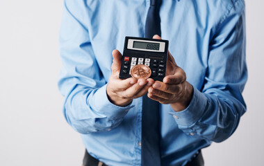 A man holds in his hands a Bitcoin cryptocurrency price increase calculator financial technology