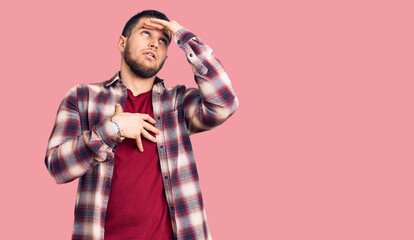 Young handsome man wearing casual shirt touching forehead for illness and fever, flu and cold, virus sick