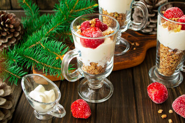 healthy yoghurt with strawberry and muesli in glass on a rustic table setting.