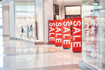 Sale red sign at mall. Discount concept. Market interior design. Selling business model. Lifestyle promotion. Store promo graphic. Shop background. Cheap boutique. Retail commercial price. Money offer