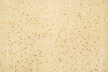 Holiday beige sparkle background with gold glitter, soft focus.