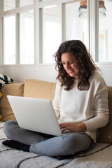 Young woman working from home with laptop