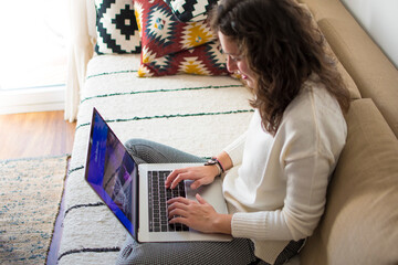 Young woman working from home with laptop