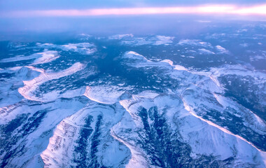 Fototapeta premium flying over rockies in airplane from salt lake city at sunset