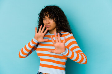 Young african american afro woman isolated rejecting someone showing a gesture of disgust.