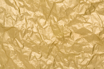 Gold paper texture. Wrinkled matte golden foil abstract background.