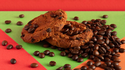 Oatmeal cookies, mug with coffee, saucer and coffee beans scattered on burlap tablecloth.