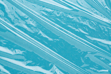 Fototapeta premium Wrinkled cling film, plastic texture, vinyl background. Blue abstract backdrop.