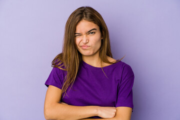 Fototapeta premium Young skinny caucasian girl teenager on purple background unhappy looking in camera with sarcastic expression.