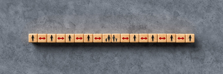 wooden cubes with person icons separated by arrows on concrete background