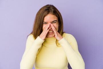 Young skinny caucasian girl teenager on purple background saying a gossip, pointing to side reporting something.