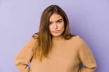 Fototapeta premium Young skinny caucasian girl teenager on purple background sad, serious face, feeling miserable and displeased.