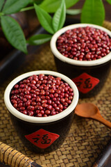 Red beans on the background of retro Chinese style.The Chinese meaning in the picture is happiness