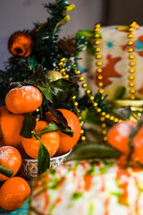 Tangerines on a blue table in Christmas style. New year and christmas decoration. Vertical orientation