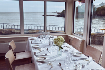 Ceremony table prepared for ceremony, beautiful table, flowers, cutlery and view of a port with a...