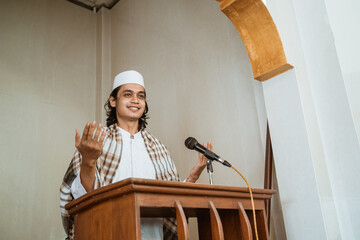 Portrait of muslim male preacher speech sharing about islam during prayer time in the mosque