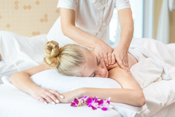 Obraz na płótnie Canvas Young beautiful Caucasian woman lying on spa bed get back massage treatment with aroma essential oil skincare from professional massage therapist at beauty salon. Wellness body massage and spa concept