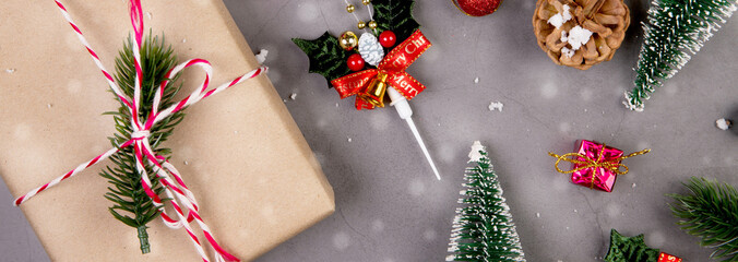 Christmas holiday composition with gift box and snow decoration, new year and xmas or anniversary with presents on cement floor background in season, top view or flat lay, copy space, banner website.