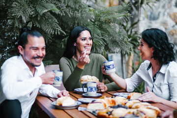 mexican friends eating Rosca de reyes or Epiphany cake, Roscon de reyes with traditional mexican...