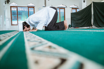 Man muslim doing prayer in the mosque