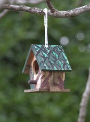 Painted wooden houses for the children to hook them to the trees