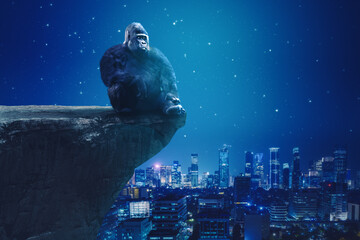 Gorilla sitting on cliff with glowing city background