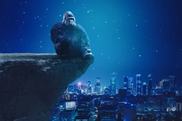 Foto op Plexiglas Gorilla sitting on cliff with glowing city background © Creativa Images