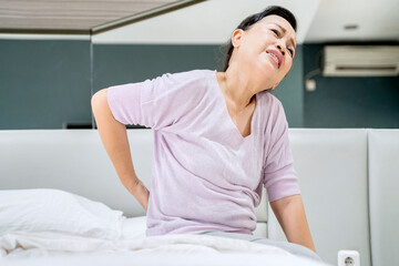 Old woman having backache after wake up at home