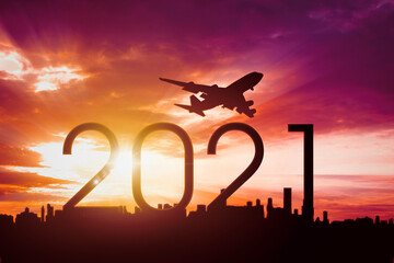 Aircraft flying in sky above 2021 numbers and city