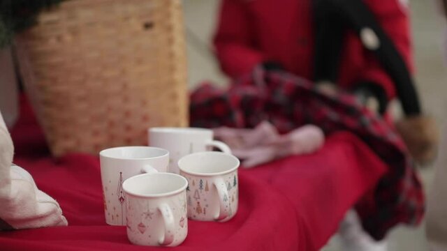 Stock video of unrecognizable woman in beige taking off her winter gloves and taking thermos