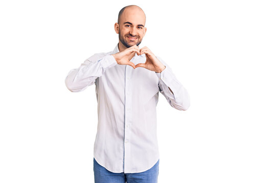 Young handsome man wearing elegant shirt smiling in love showing heart symbol and shape with hands. romantic concept.