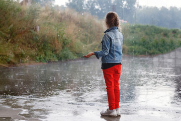 Child on the sidewalk in the rain