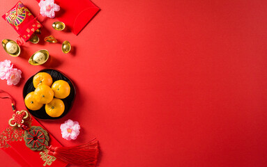 Fototapeta na wymiar Chinese new year festival decorations pow or red packet, orange and gold ingots or golden lump on a red background. Chinese characters FU in the article refer to fortune good luck, wealth, money flow.