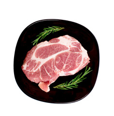 Pieces of raw pork steak in black plate.top view