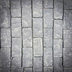 Sidewalk. Rectangular cobblestones. Construction industry. Stone background. Copy space for text.