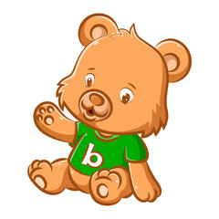 The little doll bear is sitting with the green shirt and the alphabet in the center