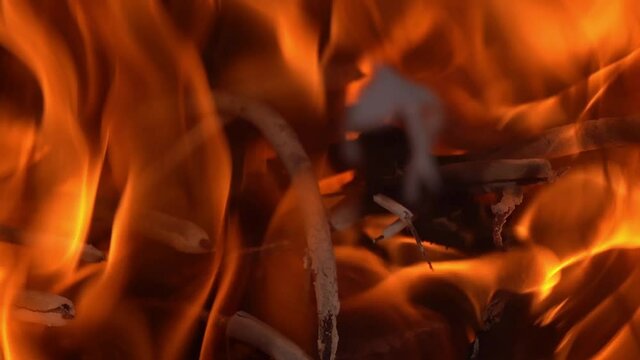 Slow motion burning the devotion joss stick at furnace.