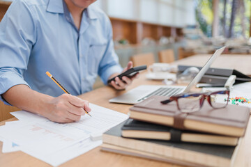 businessman using pencil checking document data calculator for calculate budget accountancy. finance and accounting concept