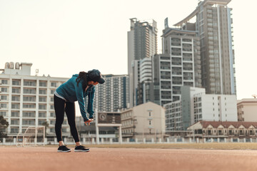 Sport health in earphone to listen music and stretching outdoor city.