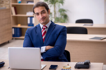 Young male employee sitting in the office