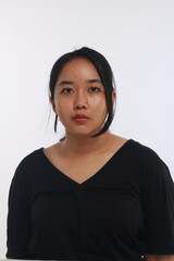 Young Asian woman with no make up on white background.