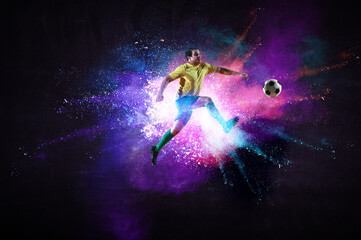 Obraz na płótnie Canvas Boy playing soccer hitting the ball