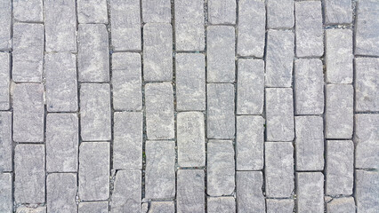 Sidewalk. Rectangular cobblestones. Construction industry. Stone background. Copy space for text.