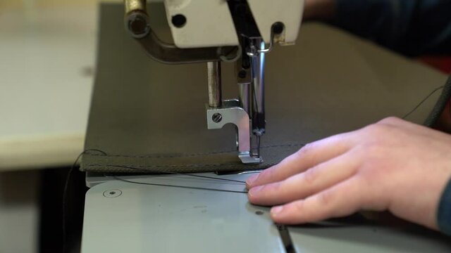 Industrial sewing machine on stitching heavy canvas