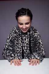 woman in hoodie, studio portrait on gray background