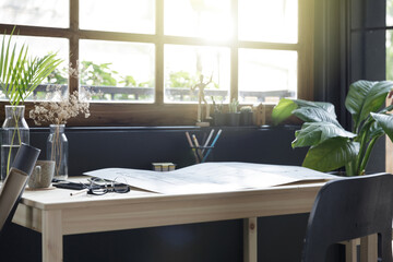 Modern home office creative space perfect for working from home lifestyle with laptop on the desk and sofa in the living room, Quarantine isolation during the Coronavirus (COVID-19) health crisis