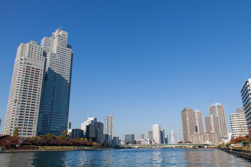 High-rise buildings against blue sky in Tokyo